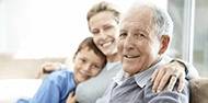 Elderly man posing with daughter and grandson